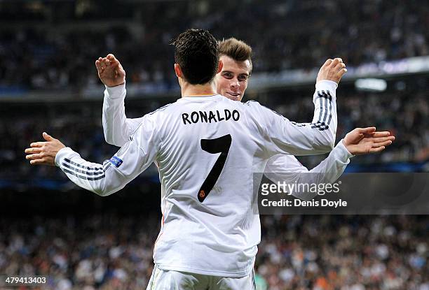 Cristiano Ronaldo of Real Madrid celebrates with teammate Gareth Bale after scoring his team's second goal during the UEFA Champions League Round of...