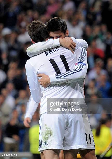 Alvaro Morata of Real Madrid is congratulated by teammate Gareth Bale after scoring his team's third goal during the UEFA Champions League Round of...