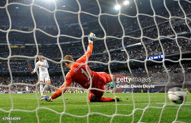 Goalkeeper Ralf Fahrmann of Schalke dives in vain as Alvaro Morata of Real Madrid scores his team's third goal during the UEFA Champions League Round...
