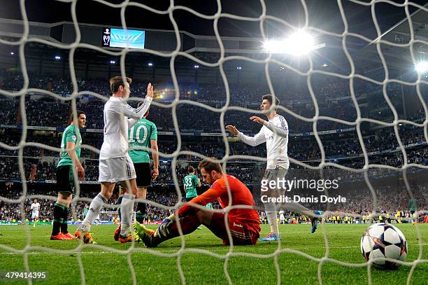 Alvaro Morata of Real Madrid is congratulated by teammate Gareth Bale after scoring his team's third goal, whilst dejected goalkeeper Ralf Fahrmann...