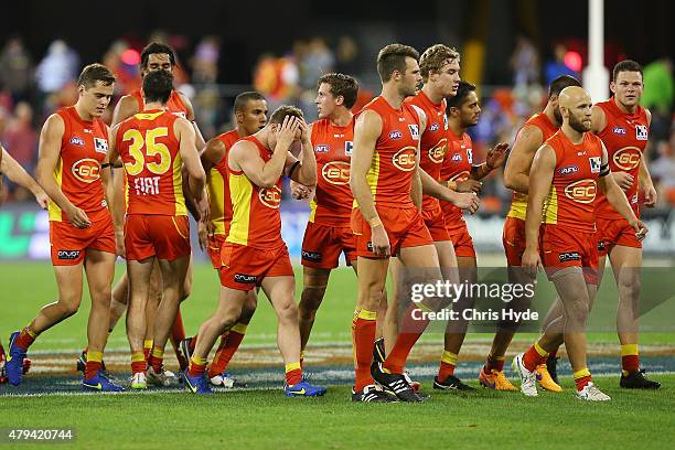 Suns leave the field at half time during the round 14 AFL match between the Gold Coast Suns and the North Melbourne Kangaroos at Metricon Stadium on...