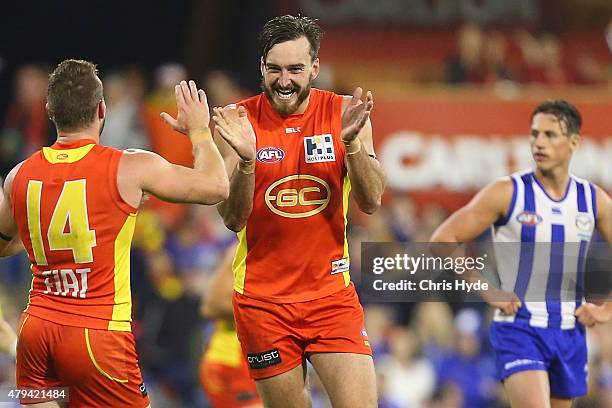 Charlie Dixon of the Suns celebrates a goal during the round 14 AFL match between the Gold Coast Suns and the North Melbourne Kangaroos at Metricon...