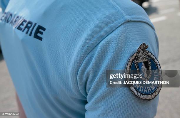 Picture taken on July 4, 2015 shows the bagde of a French police officers from the gendarmerie during a traffic control at a motorway tollbooth in...