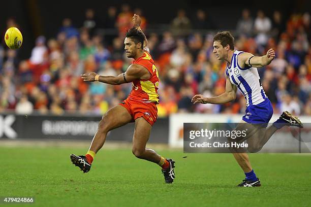Aaron Hall of the Suns kicks during the round 14 AFL match between the Gold Coast Suns and the North Melbourne Kangaroos at Metricon Stadium on July...