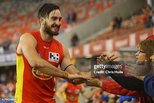 Charlie Dixon of the Suns celebrates winning the round 14 AFL match between the Gold Coast Suns and the North Melbourne Kangaroos at Metricon Stadium...