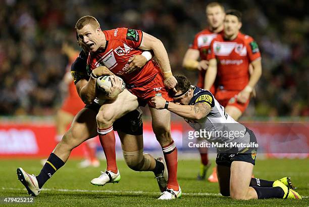 Ben Creagh of the Dragons is tackled during the round 17 NRL match between the St George Illawarra Dragons and the North Queensland Cowboys at WIN...