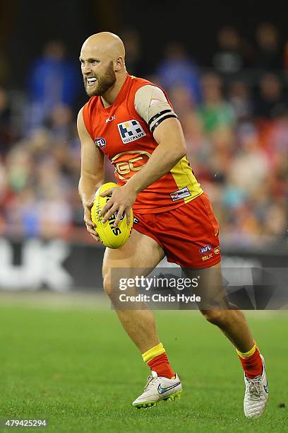 Gary Ablett of the Suns runs the ball during the round 14 AFL match between the Gold Coast Suns and the North Melbourne Kangaroos at Metricon Stadium...