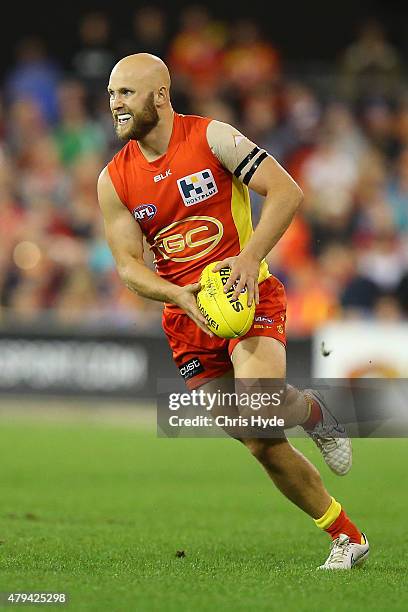 Gary Ablett of the Suns runs the ball during the round 14 AFL match between the Gold Coast Suns and the North Melbourne Kangaroos at Metricon Stadium...