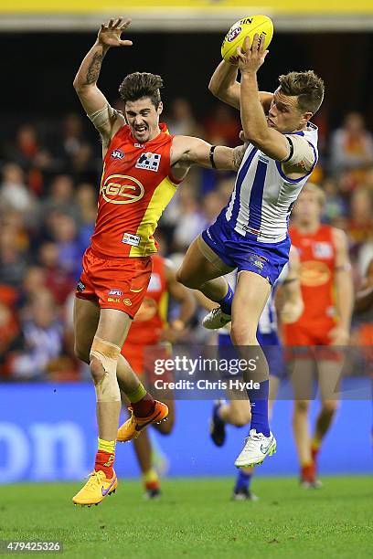 Shaun Higgins of the Kangaroos takes a mark during the round 14 AFL match between the Gold Coast Suns and the North Melbourne Kangaroos at Metricon...