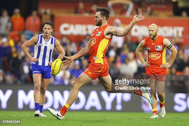 Charlie Dixon of the Suns kicks during the round 14 AFL match between the Gold Coast Suns and the North Melbourne Kangaroos at Metricon Stadium on...
