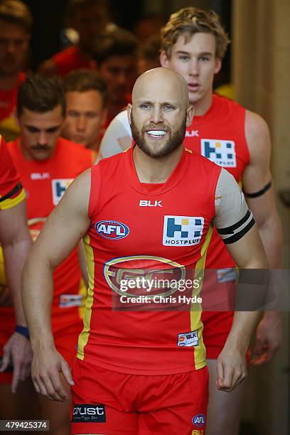 Gary Ablett of the Suns leads the team out for the round 14 AFL match between the Gold Coast Suns and the North Melbourne Kangaroos at Metricon...