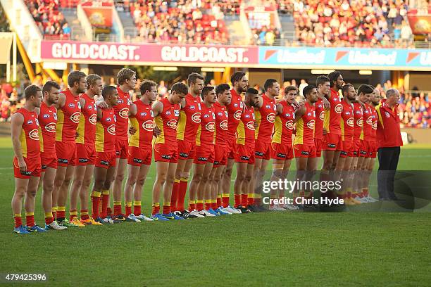 Suns pay respect to Phil Walsh before the round 14 AFL match between the Gold Coast Suns and the North Melbourne Kangaroos at Metricon Stadium on...