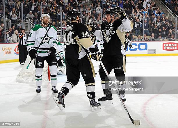 Chris Kunitz celebrates his goal with Sidney Crosby of the Pittsburgh Penguins in front of Alex Goligoski of the Dallas Stars on March 18, 2014 at...