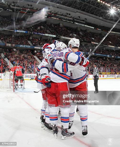 Derick Brassard the New York Rangers celebrates his second period goal against Robin Lehner of the Ottawa Senators with teammates at Canadian Tire...