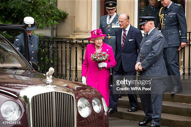 Queen Elizabeth II and Prince Philip, Duke of Edinburgh are accompanied by Commanding Officer Jerry Riley during a visit to the headquarters of the...