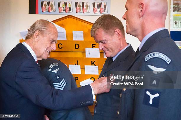 Prince Philip, Duke of Edinburgh presents an Afghanistan Service Medal to Senior Aircraftman Martin Carrigan during a visit to the headquarters of...