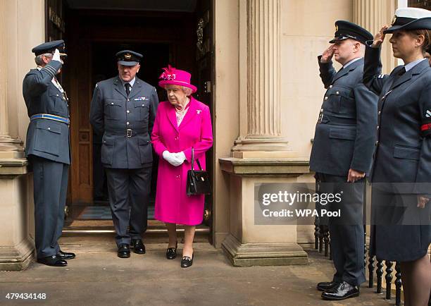 Queen Elizabeth II is accompanied by Commanding Officer Jerry Riley during a visit to the headquarters of the Royal Auxiliary Air Force's 603...