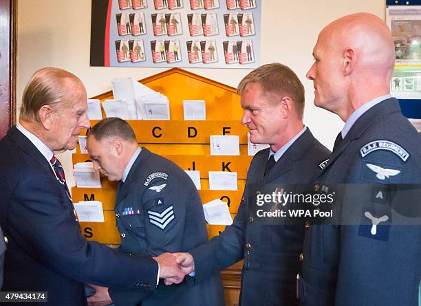 Prince Philip, Duke of Edinburgh presents an Afghanistan Service Medal to Senior Aircraftman Martin Carrigan during a visit to the headquarters of...