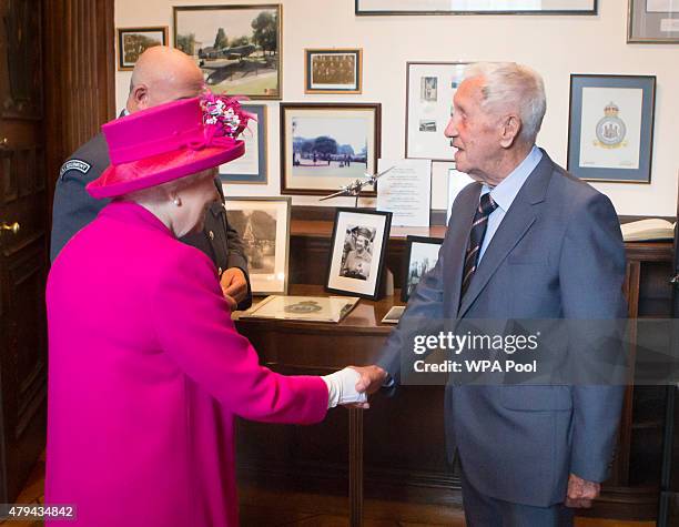 Queen Elizabeth II meet Second World War pilot Allan Scott during a visit to the headquarters of the Royal Auxiliary Air Force's 603 Squadron on July...