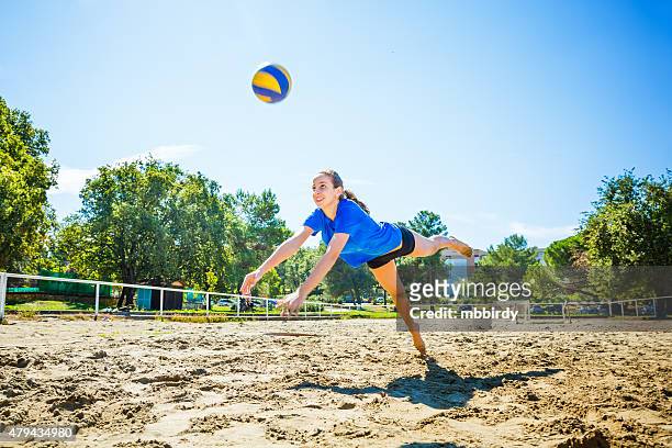 young woman playing beach volleyball - girls beach volleyball stock pictures, royalty-free photos & images