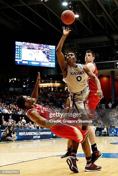 Semaj Christon of the Xavier Musketeers fouls Lennard Freeman of the North Carolina State Wolfpack in the first half during the first round of the...