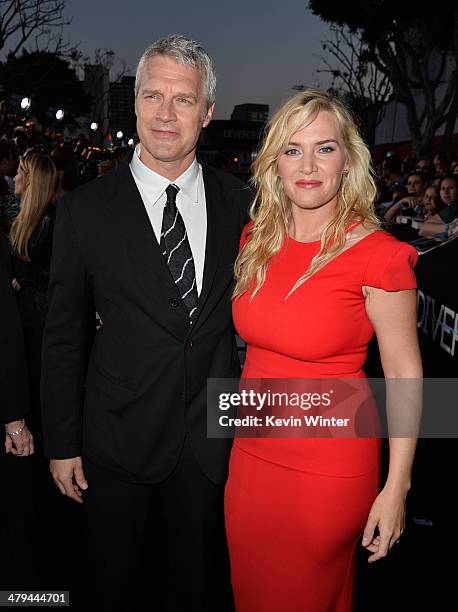 Director Neil Burger and actress Kate Winslet arrive at the premiere of Summit Entertainment's "Divergent" at the Regency Bruin Theatre on March 18,...