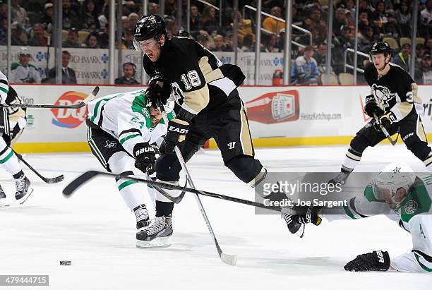 James Neal of the Pittsburgh Penguins breaks through the defense of Jordie Benn and Brenden Dillon of the Dallas Stars on March 18, 2014 at Consol...