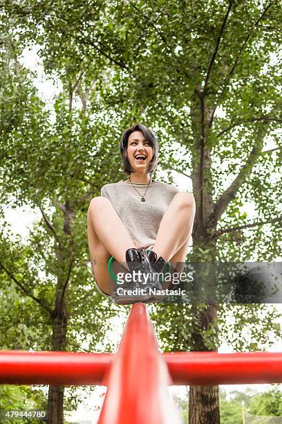 girl riding red seesaw - see saw stock pictures, royalty-free photos & images
