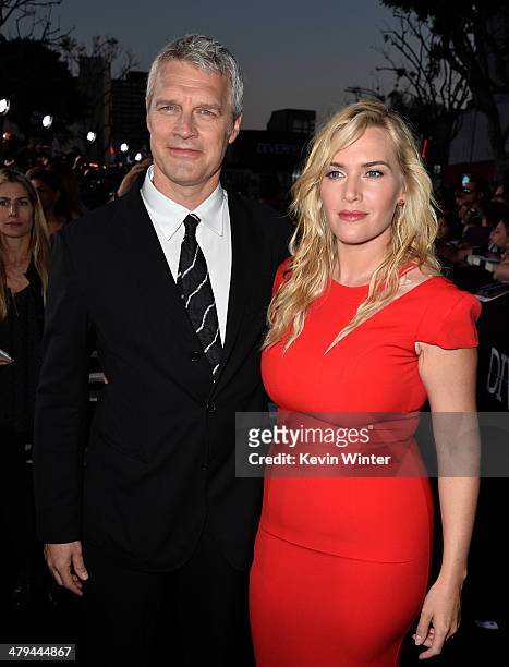 Director Neil Burger and actress Kate Winslet arrive at the premiere of Summit Entertainment's "Divergent" at the Regency Bruin Theatre on March 18,...