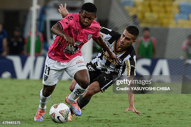 Jonathan Gonzalez of Ecuador's Independiente del Valle vies for the ball with Gabriel of Brazil's Botafogo during their 2014 Copa Libertadores...