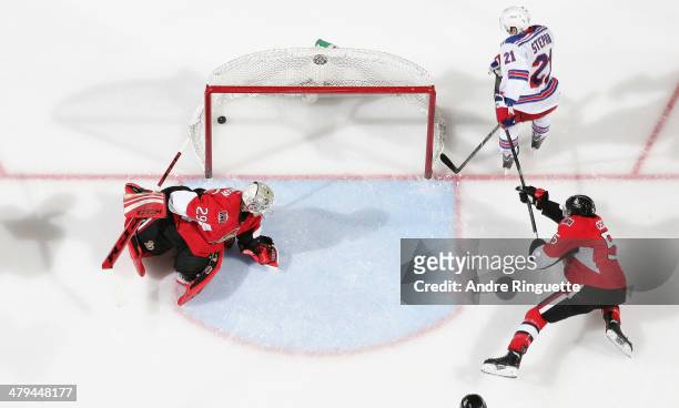 Derek Stepan of the New York Rangers scores a third period goal against Nathan Lawson and Cody Ceci of the Ottawa Senators at Canadian Tire Centre on...
