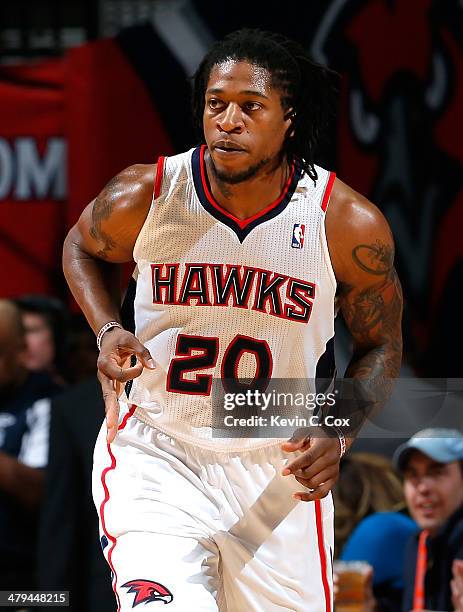 Cartier Martin of the Atlanta Hawks reacts after hitting a three-point basket against the Toronto Raptors at Philips Arena on March 18, 2014 in...