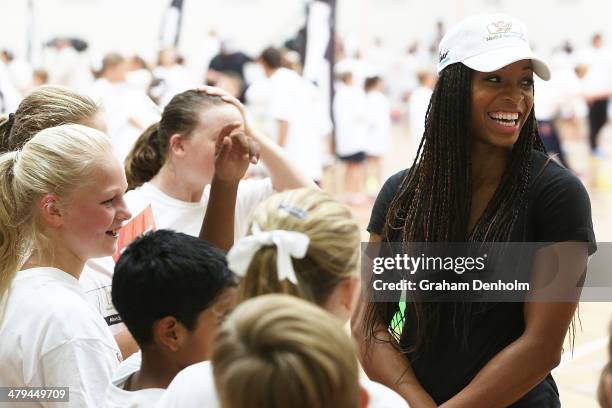 Natasha Hastings of the United States talks to a group of young boys and girls during the launch of the IAAF Nestle Healthy Active Kids Athletics at...