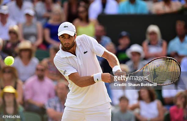 Pablo Andujar of Spain plays a backhand his Mens Singles Third Round match against Tomas Berdych of Czech Republic during day six of the Wimbledon...
