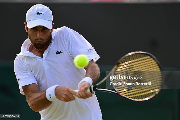 Pablo Andujar of Spain plays a backhand his Mens Singles Third Round match against Tomas Berdych of Czech Republic during day six of the Wimbledon...