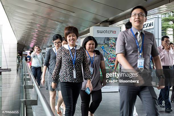 Office workers walk along a footbridge during lunch hour in Kuala Lumpur, Malaysia, on Tuesday, March 18, 2014. Malaysia, aspiring to become a...