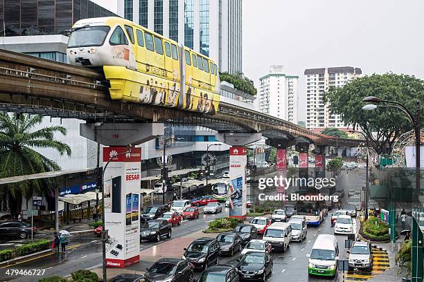 Monorail train, operated by Rapid Rail Sdn Bhd, moves along an elevated track above road traffic in Kuala Lumpur, Malaysia, on Tuesday, March 18,...