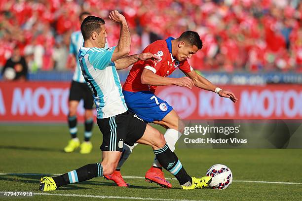 Alexis Sanchez of Chile fights for the ball with Martin Demichelis of Argentina during the 2015 Copa America Chile Final match between Chile and...