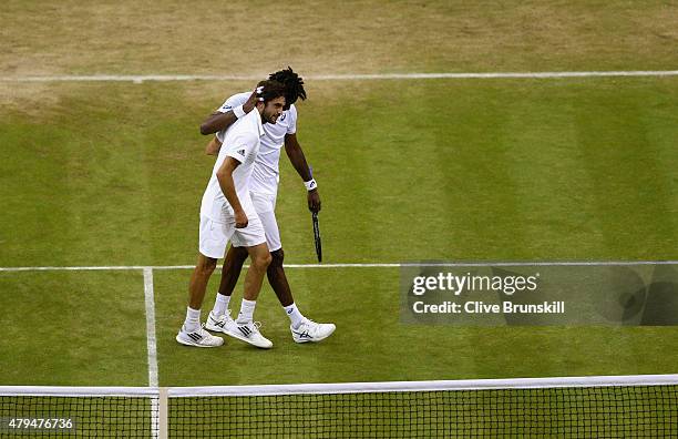 Gilles Simon of France is congratulated by Gael Monfils of France after their Mens Singles Third Round during day six of the Wimbledon Lawn Tennis...