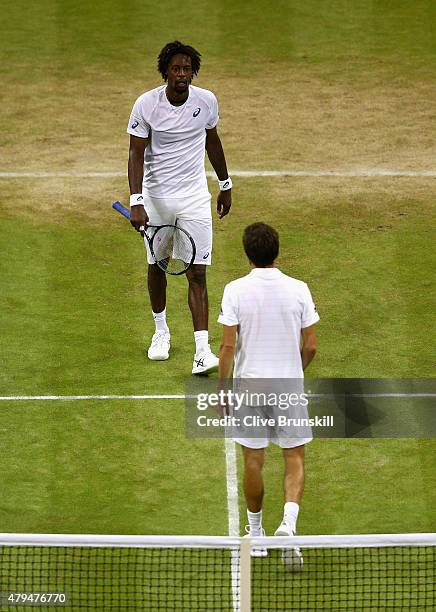 Gilles Simon of France crosses to see Gael Monfils of France to console him after their Mens Singles Third Round during day six of the Wimbledon Lawn...