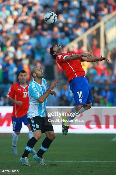 Jorge Valdivia of Chile goes for a header with Javier Mascherano of Argentina during the 2015 Copa America Chile Final match between Chile and...