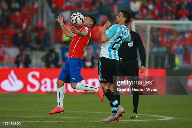 Charles Aranguiz of Chile fights for the ball with Javier Pastore of Argentina during the 2015 Copa America Chile Final match between Chile and...