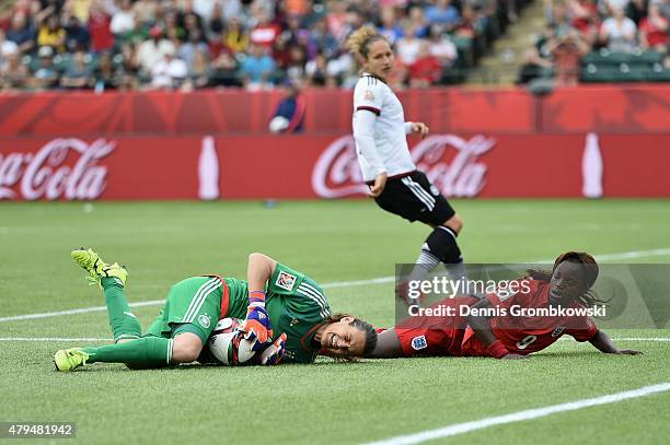 Nadine Angerer of Germany is challenged by Eniola Aluko of England during the FIFA Women's World Cup Canada 2015 Third Place Play-off match between...