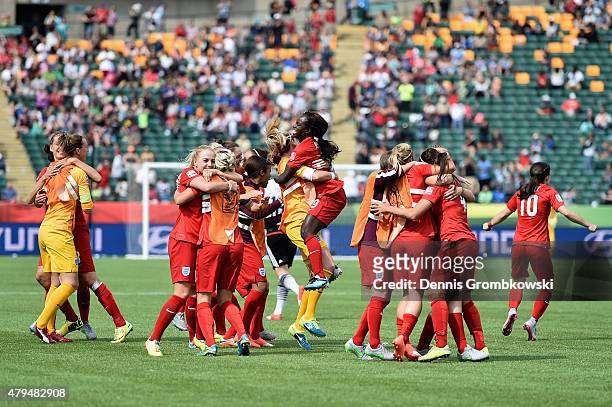 Fara Williams of England celebrates with team mates as she scores the opening goal from a penalty during the FIFA Women's World Cup Canada 2015 Third...
