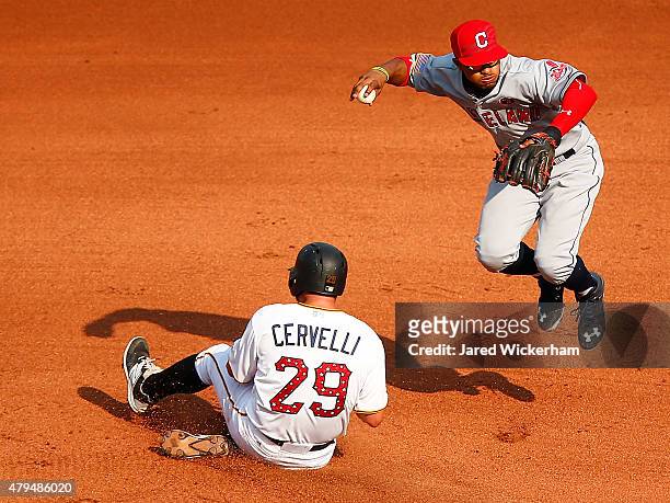 Francisco Lindor of the Cleveland Indians attempts to turn the double play over Francisco Cervelli of the Pittsburgh Pirates during the interleague...