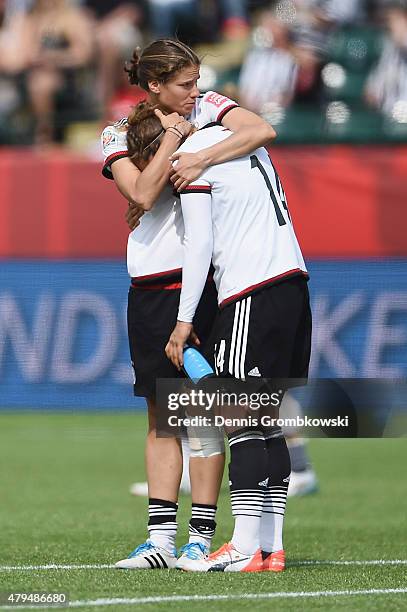 Annike Krahn of Germany hugs team mate Babett Peter after the FIFA Women's World Cup Canada 2015 Third Place Play-off match between Germany and...