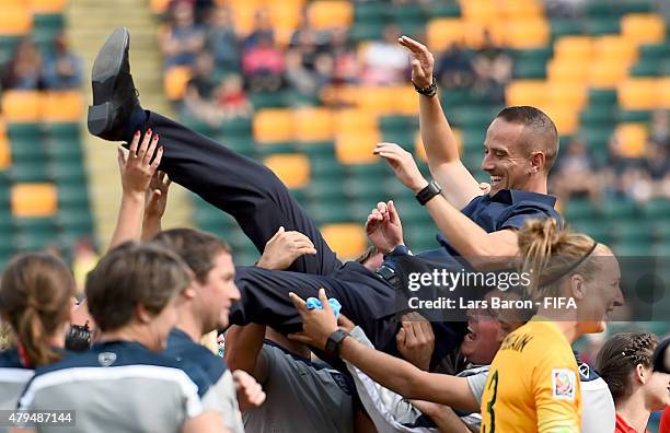 Players and team members of England throw Head coach Mark Sampson of England in the air after winning the FIFA Women's World Cup 2015 Third Place...