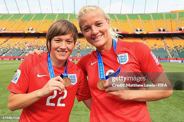 Fran Kirby and Katie Chapman of England celebrate their teams third place after defeating Germany during the FIFA Women's World Cup 2015 Third Place...