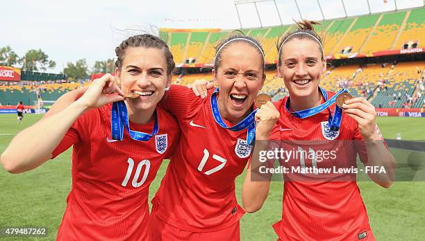 Karen Carney, Jo Potter and Jade Moore of England celebrate their teams third place after defeating Germany during the FIFA Women's World Cup 2015...