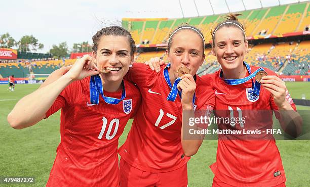 Karen Carney, Jo Potter and Jade Moore of England celebrate their teams third place after defeating Germany during the FIFA Women's World Cup 2015...